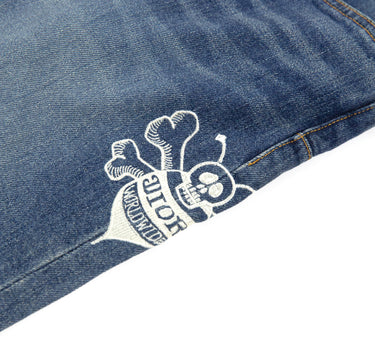 A detailed mid shot of the logo on the Dior x Stussy Bee Embroidered Jeans.