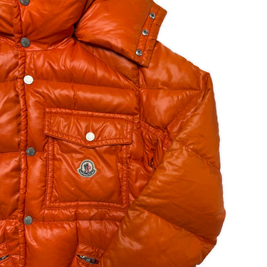 The logo of the Moncler K2 Orange Puffer Jacket.