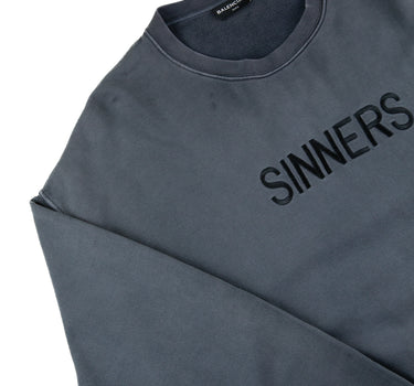 The logo of the Balenciaga Sinners Sweatshirt.