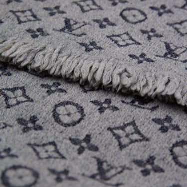 The print detail of the Louis Vuitton Grey Monogram Scarf.