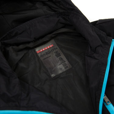 The inside label of a Prada Multicolour Zip Jacket in black.