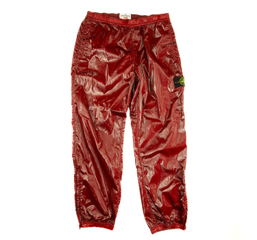 The front of the Supreme x Stone Island Cherry Red Silk Pants.