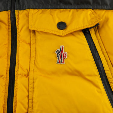 The logo of the Moncler Down Yellow Gilet.