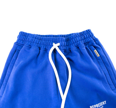 The front of the Represent Owners Club Blue Sweatpants.