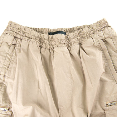 The waistband of the Represent Beige Cargo Trousers.