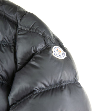 The logo of the Moncler Gaston Black Puffer Jacket.