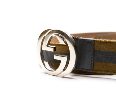 The buckle of the Gucci Blue & Yellow Striped Canvas Silver GG Buckle Belt.
