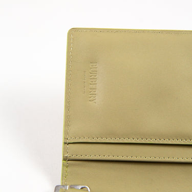 A Burberry Embossed Check Continental Wallet in Lichen Green.
