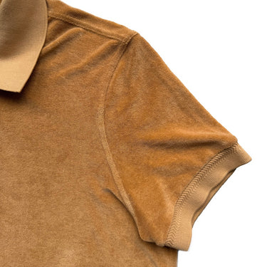 The sleeve of the Tom Ford Mustard Towelling Polo Shirt.