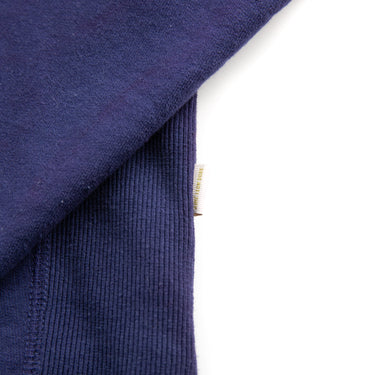 The label of the Aimé Leon Dore Logo Navy Hoodie.