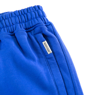 The pocket of the Represent Owners Club Blue Sweatpants.
