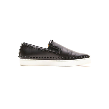 The left of the Christian Louboutin Black Spike Boat Shoes.