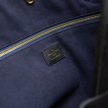 The label of the Louis Vuitton Neverfull MM Black Tote Bag.