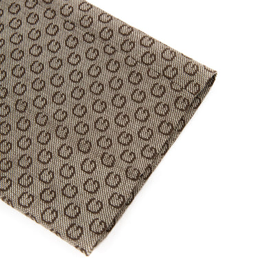 A close-up detail of Gucci G Print Trousers, Brown in color