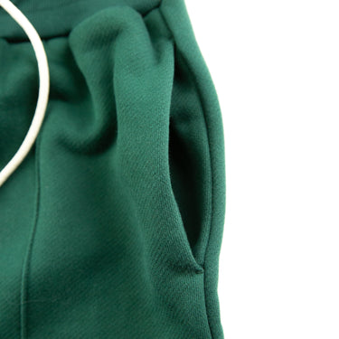 The pocket of the about:blank Green Shorts.