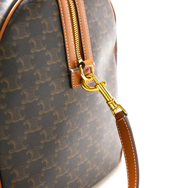 The detail of the Celine Voyage bag in Triomphe Canvas with Celine print.