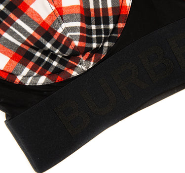 The front logo of the Burberry Red Check Bra Top.