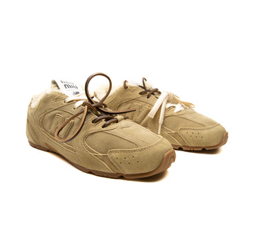 The side of the New Balance x Miu Miu 530 SL Ecru Suede Sneakers.