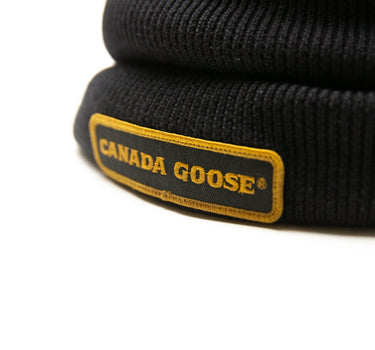 The logo of the Canada Goose Black Beanie.