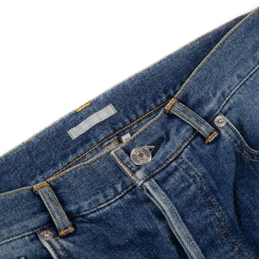 The inside label and band of the Dior x Stussy Bee Embroidered Jeans.