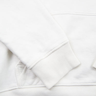 The sleeve of the Dior x Kaws Bee Embroidered White Hoodie.