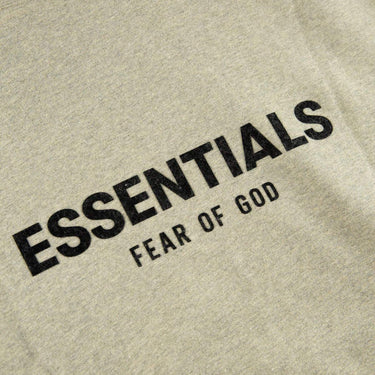 The logo of the Fear Of God ESSENTIALS Dark Oatmeal Hoodie M.