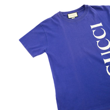 The flat lay of the Gucci Blue Spellout T Shirt.