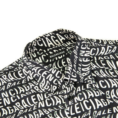 The collar of the Balenciaga All Over Wave Logo Shirt.