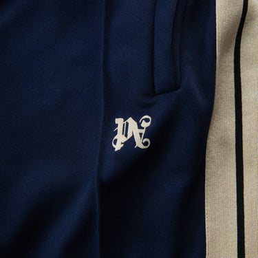 The logo of the Palm Angels Navy Embroidered Logo Sweatpants.