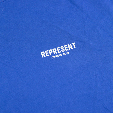 The logo of the Represent Owners Club Blue T Shirt.