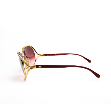 The side of Dior 2499 sunglasses in custom dark pink lenses showing off the chic design.