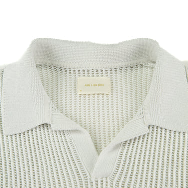 The collar of the Aime Leon Dore Mesh Knit Cream Polo M.