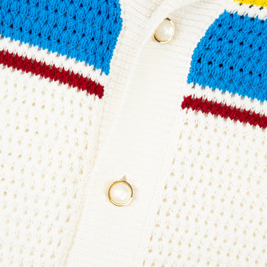 The buttons of a Casablanca Multicolor Crochet Tennis Shirt in white with intricate crocheted detailing.