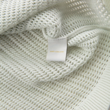 The label of the Aime Leon Dore Mesh Knit Cream Polo M.