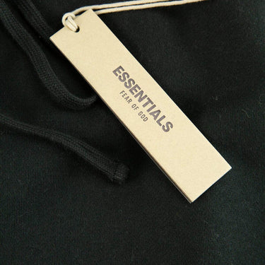 The tags of the Fear Of God ESSENTIALS Stretch Limo Sweatpants L.