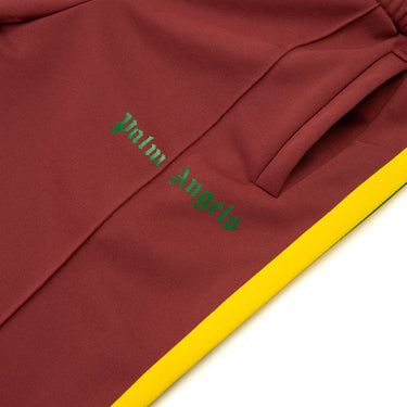 The logo of the Palm Angels Burgundy & Yellow Sweatpants.