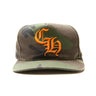 The front of the Chrome Hearts CH Camo Trucker Hat.