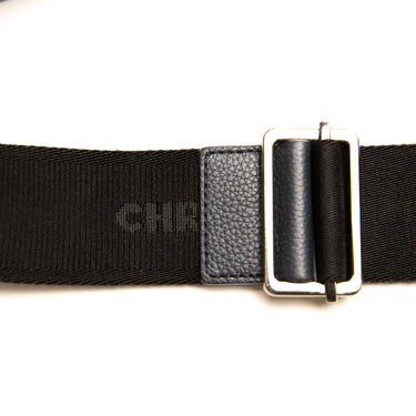 The strap of the Dior Black Oblique Saddle Bag.
