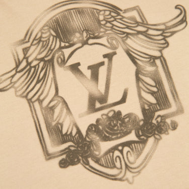 The up close of front design of the Louis Vuitton Crest Logo Beige T Shirt.