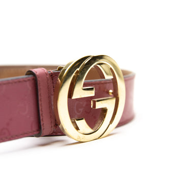 The buckle of the Gucci Pink Monogram Gold GG Buckle Belt.