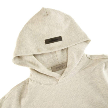 The hood of the Fear Of God ESSENTIALS Light Oatmeal Hoodie L.