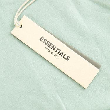 The tags of the Fear Of God ESSENTIALS Sycamore Sweatshorts Shorts M.