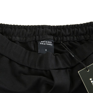 The label of the nothings something Black Classic Pants.