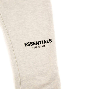 The logo of the Fear Of God ESSENTIALS Light Oatmeal Sweatpants M.