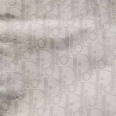 The logo of the Dior Oblique Swim Shorts.