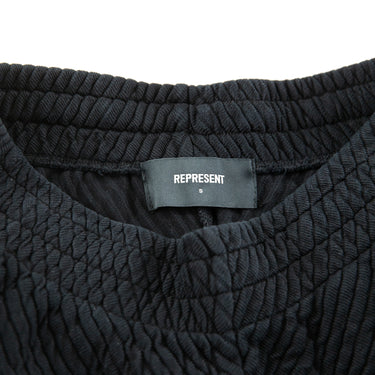 The label of the Represent Black Ottoman Shorts.