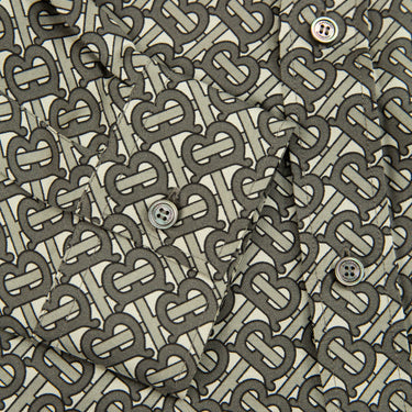 The monogram print of the Burberry TB Monogram Silk Shirt.