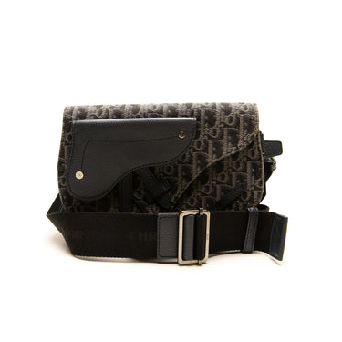 The strap of the Dior Black Oblique Saddle Bag.