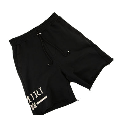 The flat lay of the Amiri Black Shorts.