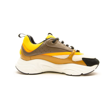 The left of the Dior B22 Ebony Camel Yellow Calfskin Trainer.